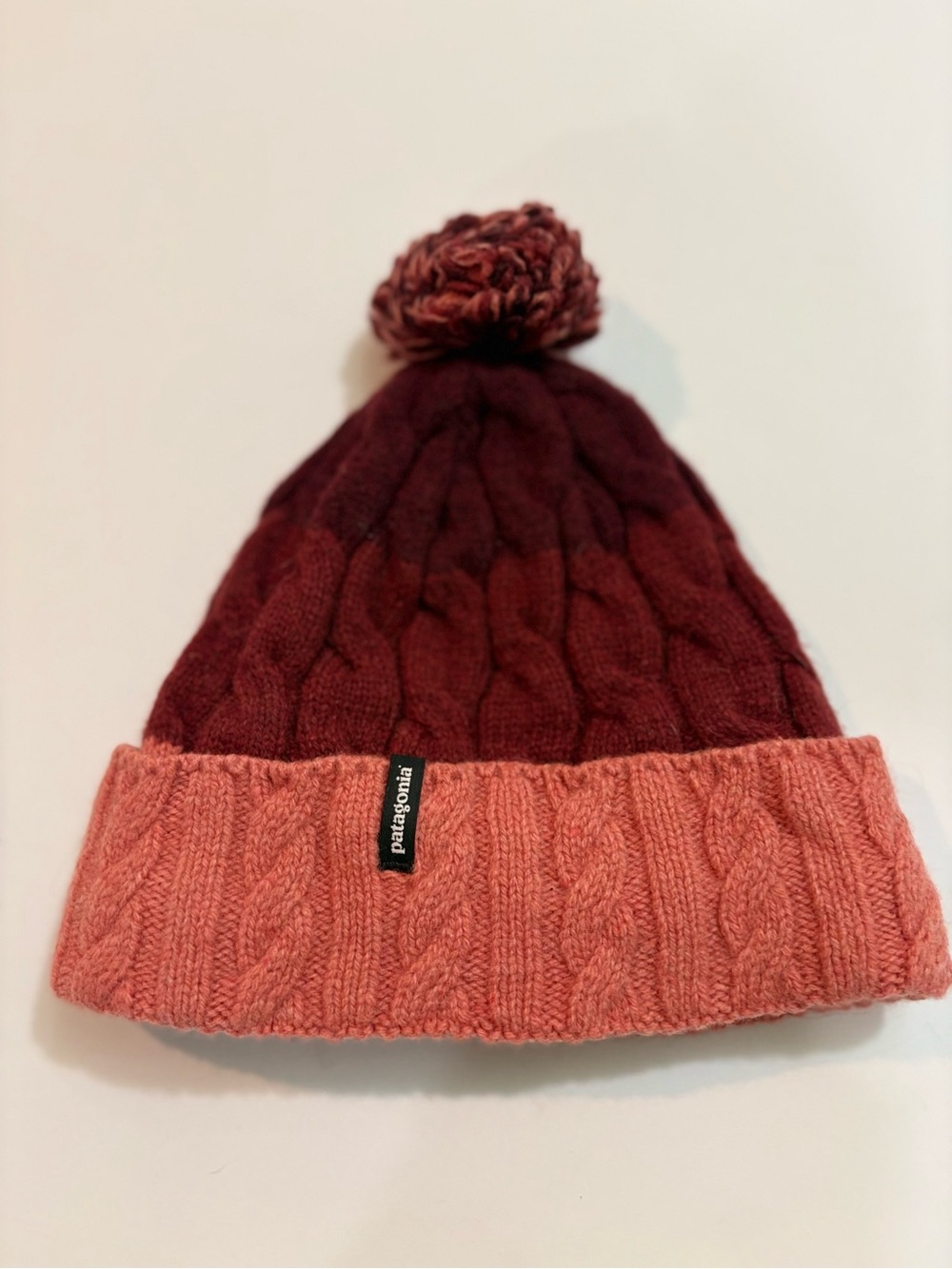Patagonia Cable Knit Pom Beanie in Burgundy and Coral Pink